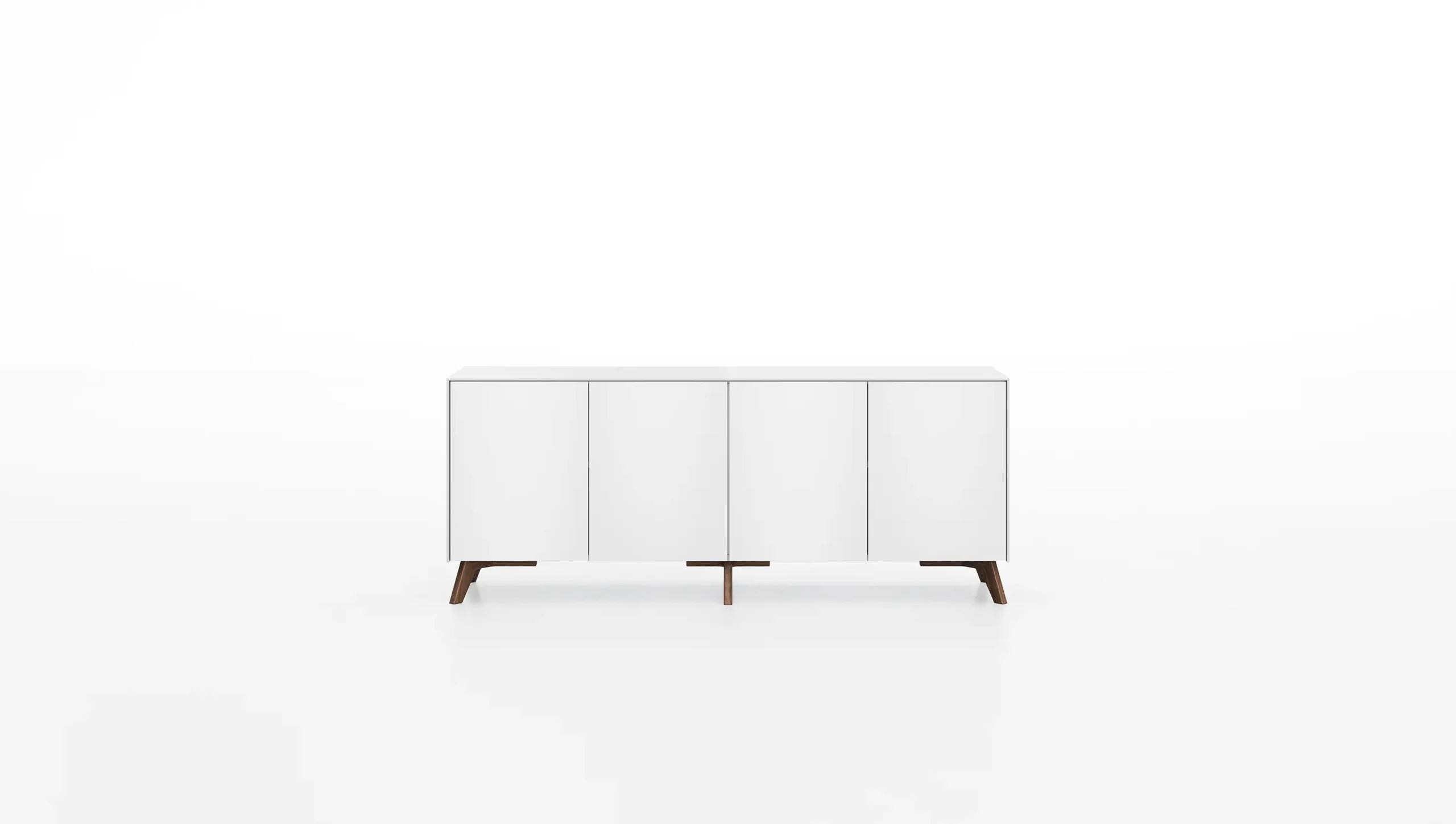 DEKKO Interiors | Αισθητική & Εργονομία στα Έπιπλα Γραφείου Η κατασκευή του γραφείου αποπνέει μια ευάερη και δυναμική αίσθηση, χάρη στην ξύλινη δομή του, η οποία είναι εμπνευσμένη από το στυλ "Mollinian". Αυτή η μοναδική κατασκευή στηρίζει είτε μια γυάλινη είτε μια ξύλινη επιφάνεια σε μια εντυπωσιακή ισορροπία αντίθετων δυνάμεων, δημιουργώντας ένα εντυπωσιακό οπτικό αποτέλεσμα. Το πολύτιμο ξύλο καρυδιάς παίζει κεντρικό ρόλο στον σχεδιασμό του γραφείου. Η επιφάνεια εργασίας, κατασκευασμένη από φυσικό καρυδιά ξύλο, είναι το αποκορύφωμα της υλικότητας και της χειροτεχνίας, με ένα συμπαγές προφίλ και στρογγυλεμένες άκρες που αναδεικνύουν τη φυσική ομορφιά του υλικού. Η γοητεία του κρυστάλλου συναντά την ισχυρή και στιβαρή αίσθηση του μαόνι kotibé στη δομή του γραφείου. Προτείνεται σε δύο εκδόσεις: λευκή και ανθρακί λάκα, προσφέροντας έτσι ευελιξία στον σχεδιασμό του εσωτερικού χώρου. Οι κρυστάλλινες επιφάνειες είναι διαθέσιμες σε τρεις εκδόσεις: εξαιρετικά διαφανές γυαλί, λευκό λακαρισμένο γυαλί, και καπνιστό γυαλί, όλα πάχους 15 mm, προσδίδοντας μία επιπλέον διάσταση πολυτέλειας.